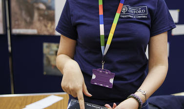 Dr Luciana Carvalho showing a picture of a copper-containing mineral