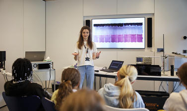Researcher explaining the principle behind detection of small pollutant particles 